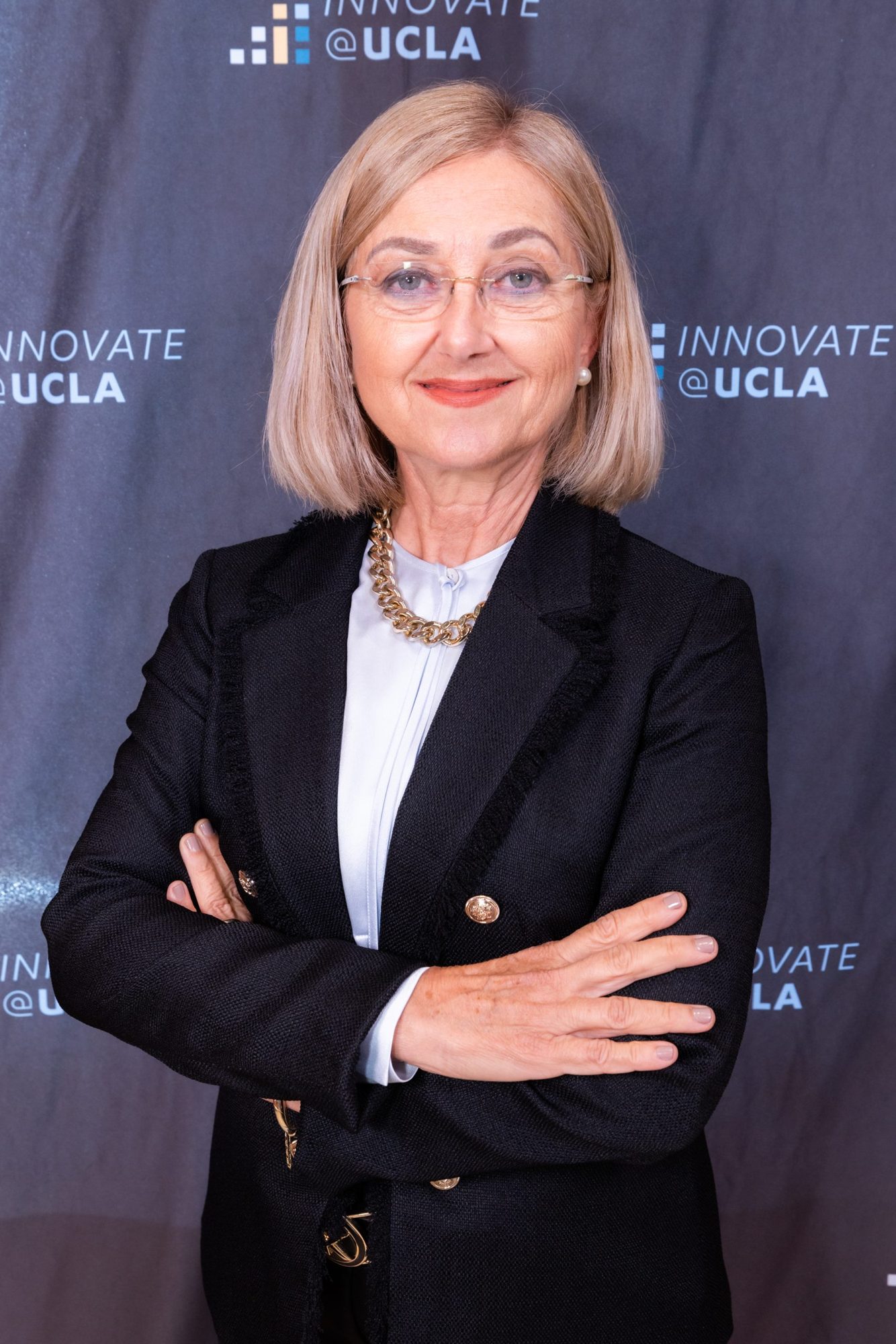 An executive portrait taken in front of an event backdrop