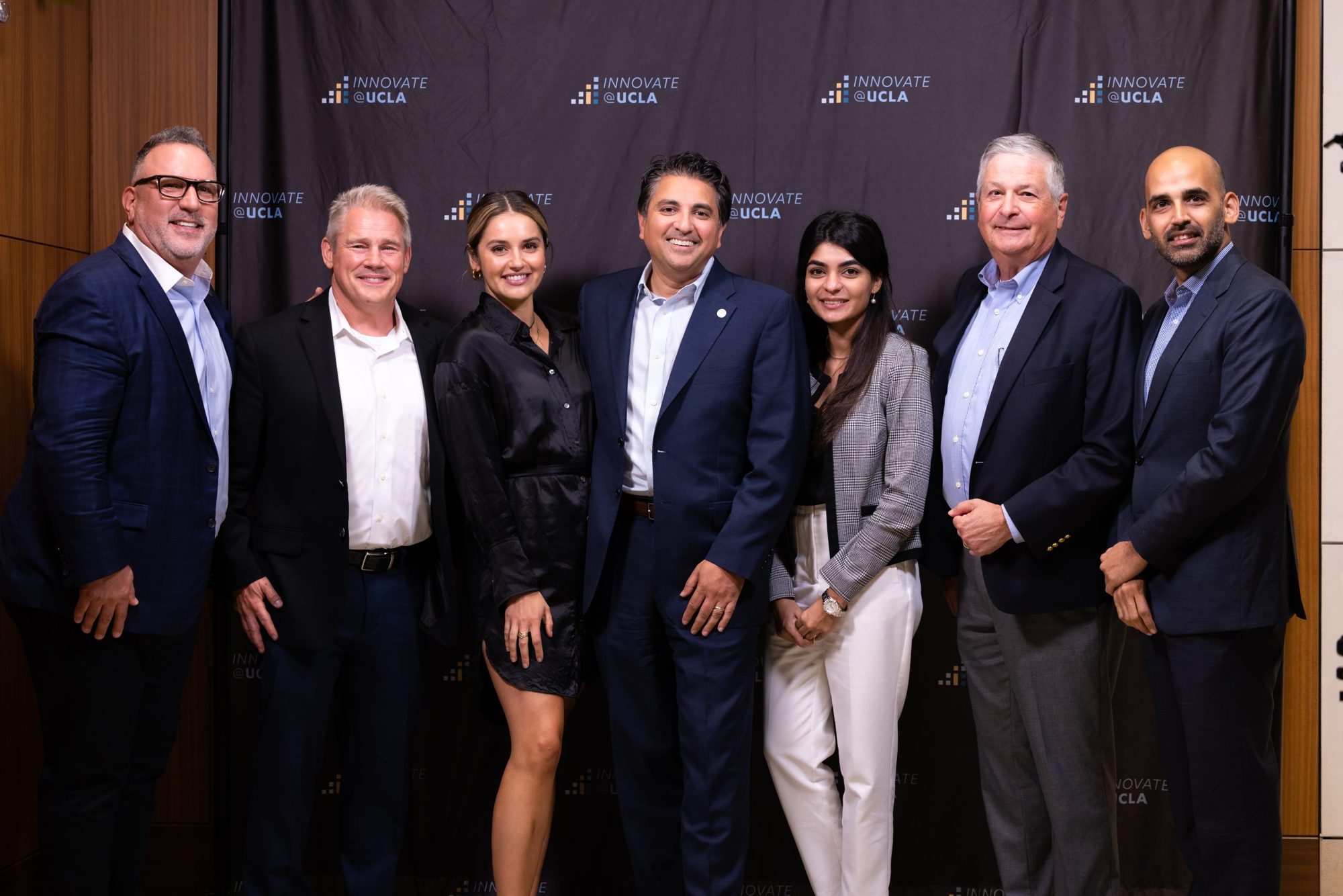 A group photo of honourees in front of the Innovate@UCLA backdrop